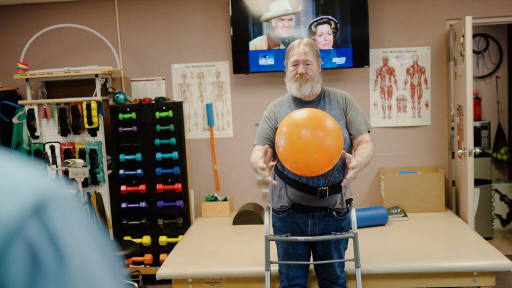 A man in physical therapy at a short term care facility
